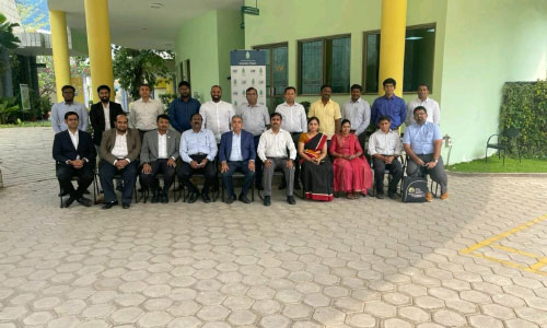 Group photo of professionals gathered for a corporate meeting or visit