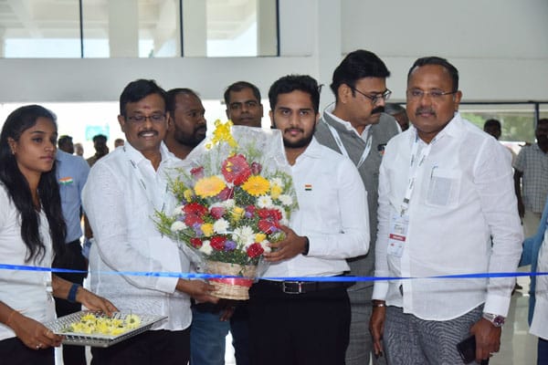 Vishaal Promoters welcoming guests with bouquet at project inauguration